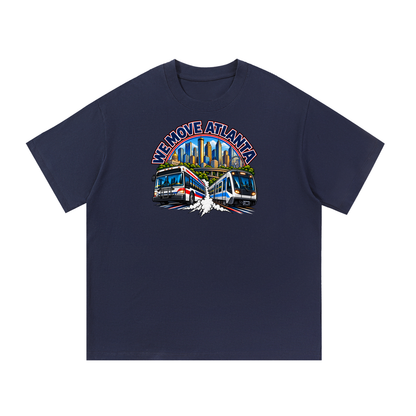 We Move Atlanta Tee — navy heavyweight cotton with the ATL transit badge featuring the Atlanta skyline, MARTA train, and bus, printed on the front.