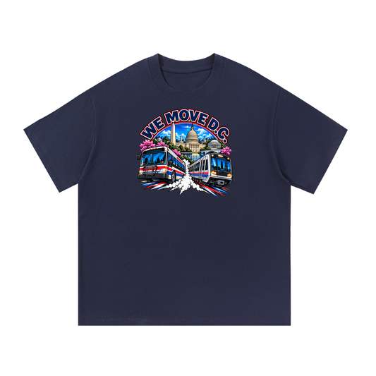 We Move DC Tee — navy heavyweight cotton with the DC transit badge featuring the Washington skyline, Metro train, and bus, printed on the front.